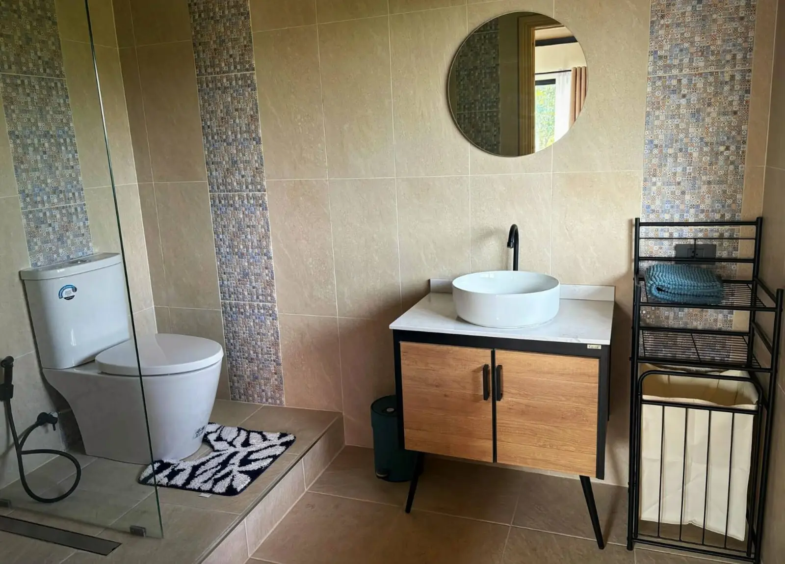 Bathroom with vessel sink and round mirror
